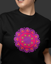 Person wearing a black t-shirt with a purple and pink mandala design on a dark background